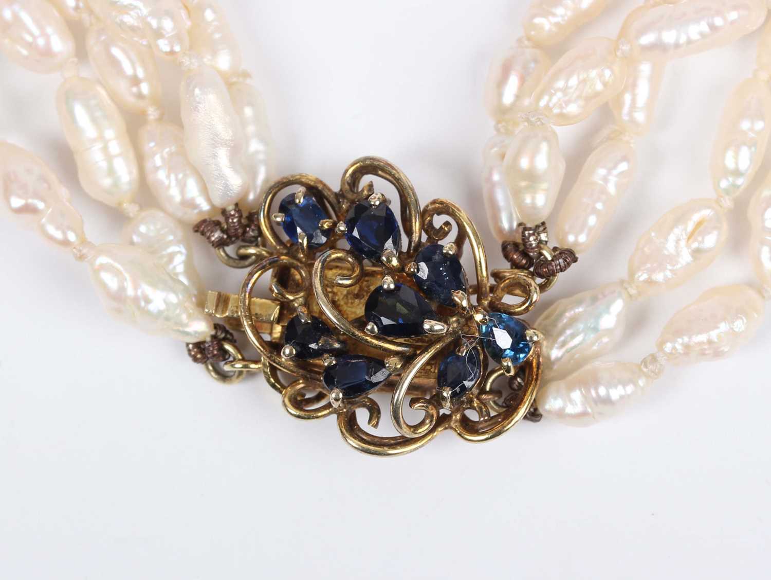 A five row necklace of freshwater cultured pearls on a gold and sapphire clasp, detailed ‘585 - Image 2 of 3