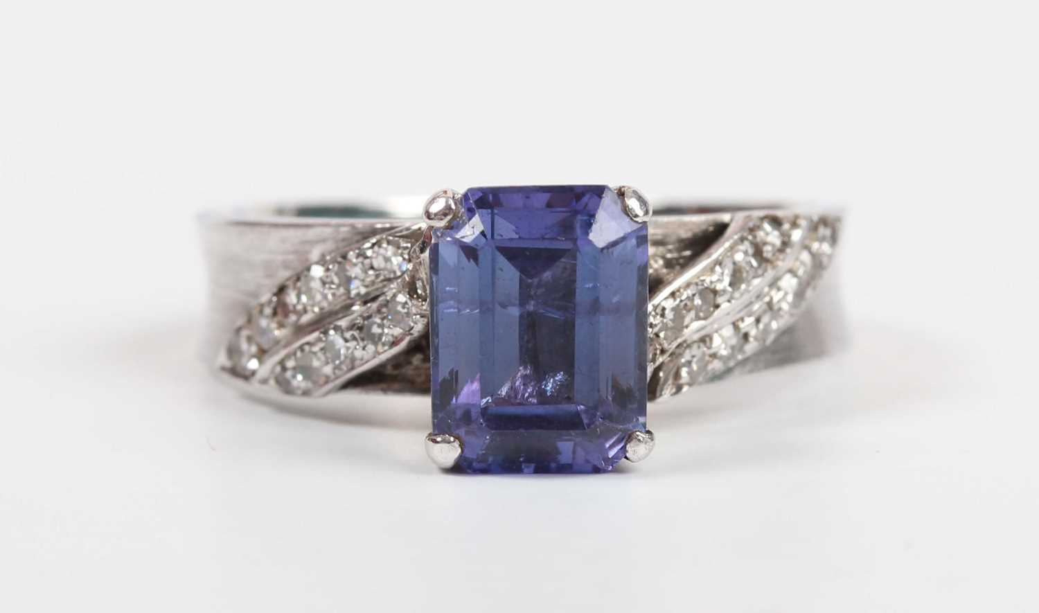 A white gold, tanzanite and diamond ring, claw set with the cut cornered rectangular tanzanite - Image 2 of 10