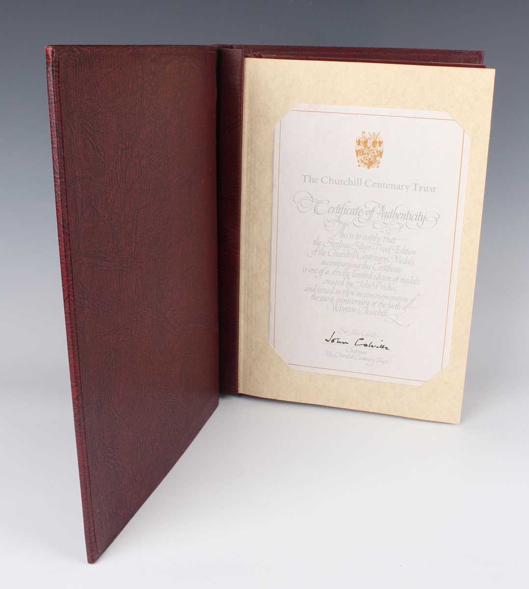 A collection of twenty-four John Pinches silver proof medallions, within an album detailed 'The