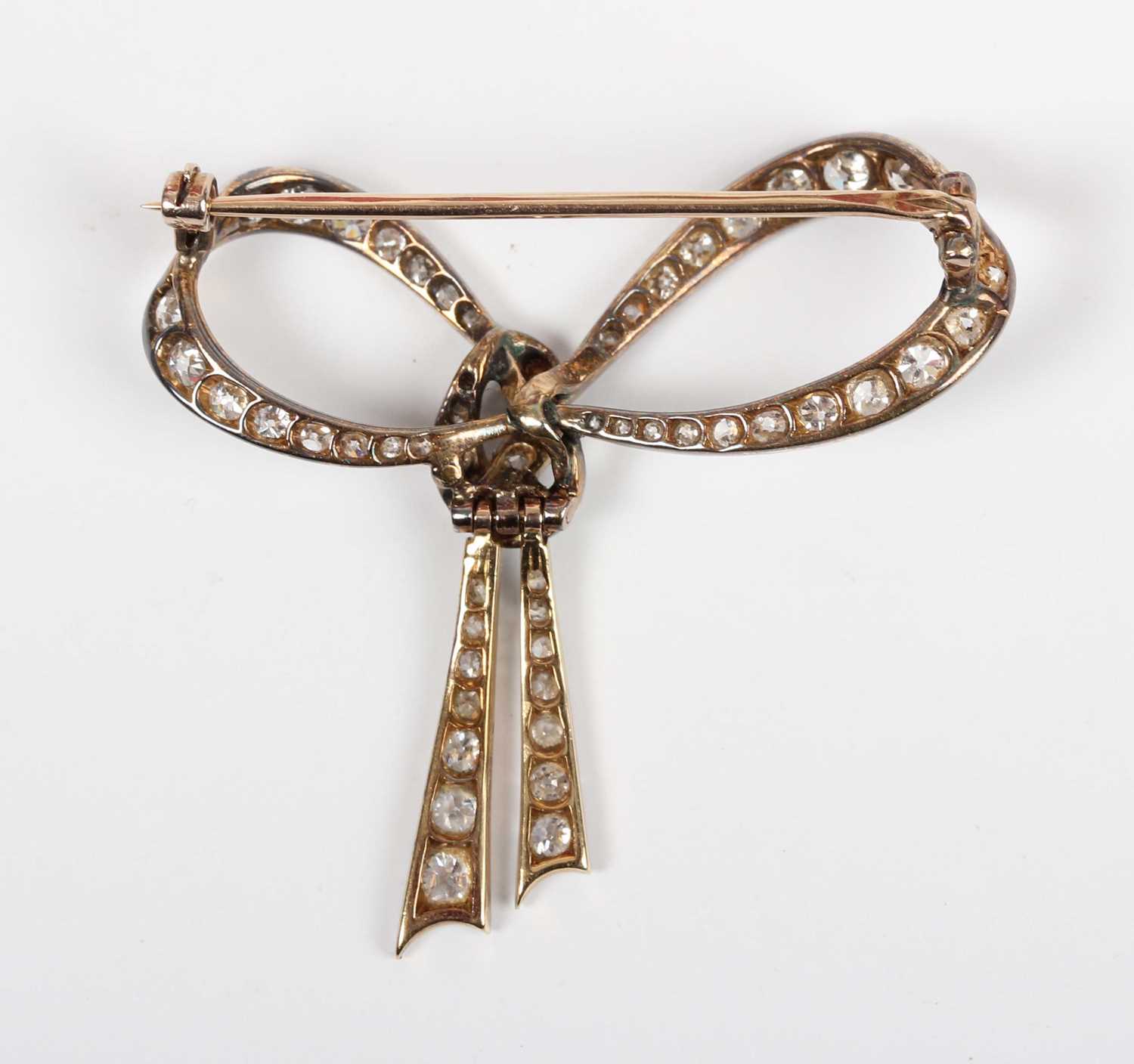 A gold backed and diamond brooch designed as a tied bow, mounted with cushion cut diamonds, - Image 2 of 3