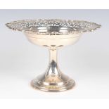 A George V silver tazza, the circular top with pierced scroll decoration within a cast scroll rim,
