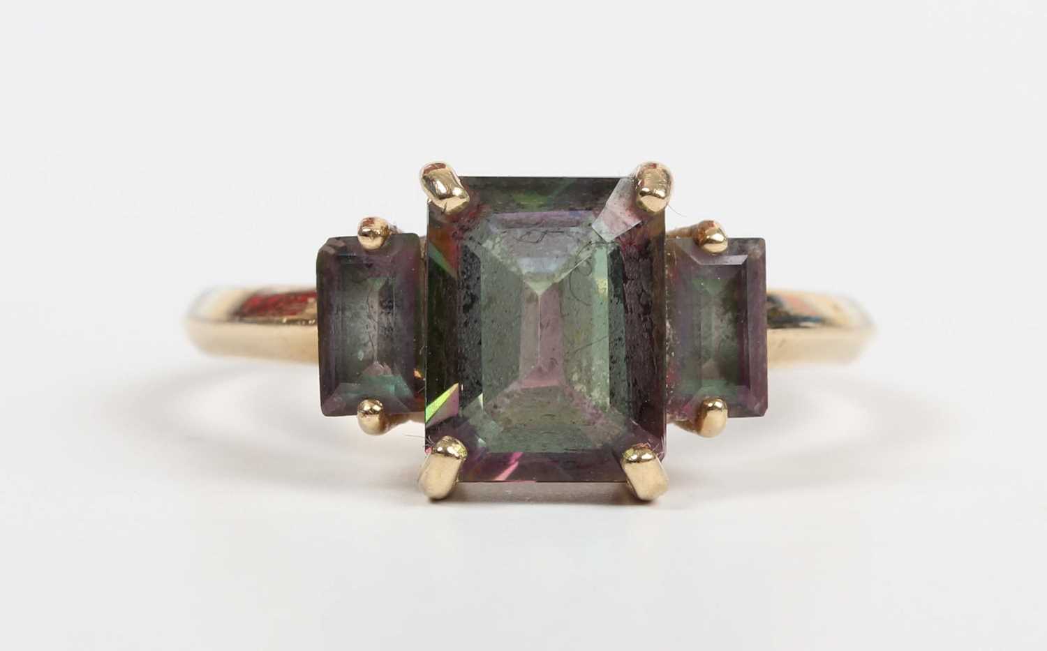 A 9ct gold ring, mounted with a cut cornered rectangular step cut mystic topaz between two smaller - Image 2 of 5