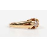 A gold and diamond single stone ring, claw set with a pale brown tinted diamond, detailed ‘18ct’,