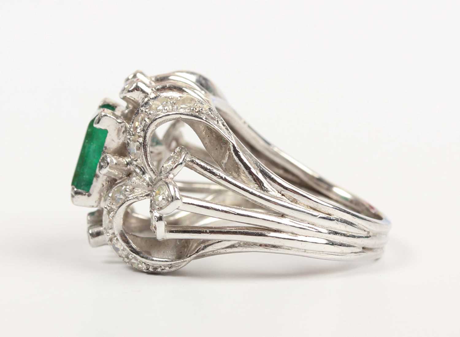 An emerald and diamond cocktail ring, claw set with the rectangular step cut emerald between - Image 3 of 5