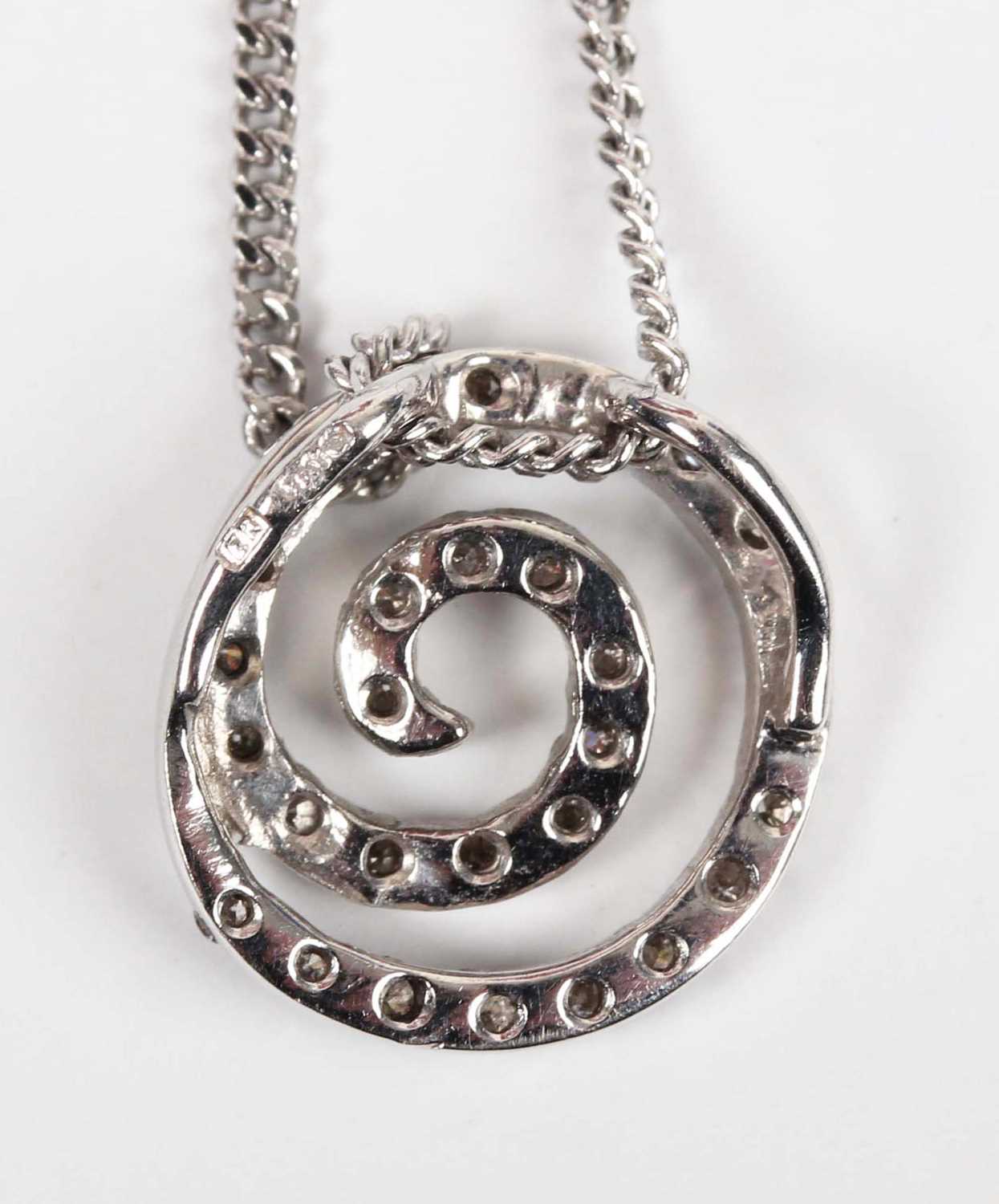 An 18ct white gold and diamond pendant in a coiled design, mounted with a circular cut diamond, - Image 3 of 3