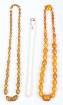 A single row necklace of graduated cultured pearls, on a gold and opal single stone clasp,