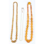 A single row necklace of graduated cultured pearls, on a gold and opal single stone clasp,