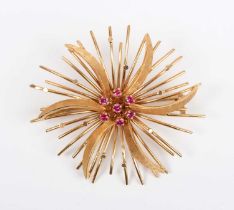 A gold and synthetic ruby brooch, 1960s, in a spiralling and wirework design, indistinct mark to