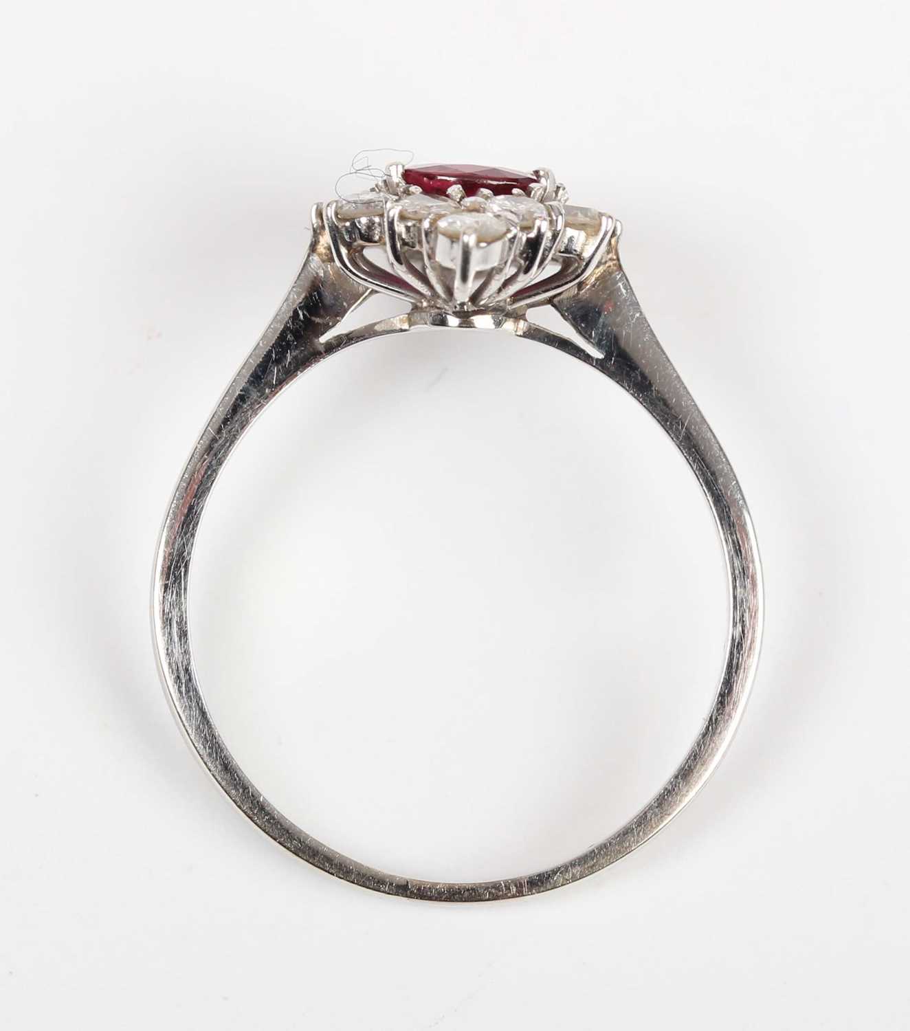 A ruby and diamond cluster ring, claw set with the oval cut ruby within a marquise shaped surround - Image 4 of 5