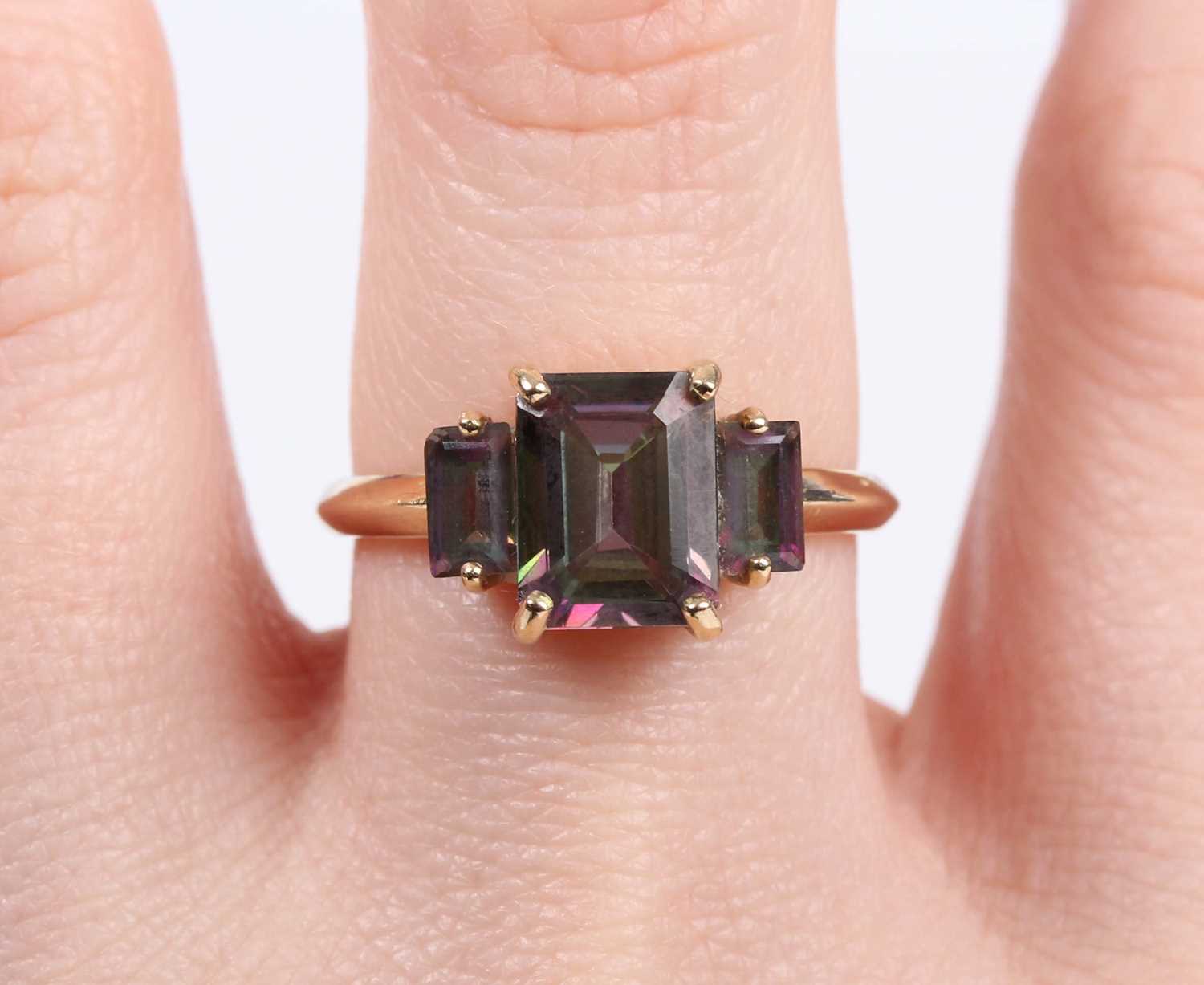 A 9ct gold ring, mounted with a cut cornered rectangular step cut mystic topaz between two smaller - Image 5 of 5