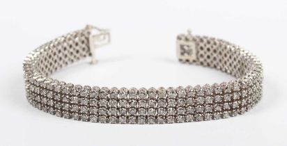 A white gold and diamond bracelet, mounted with four rows of circular cut diamonds, on a snap clasp,