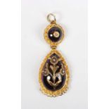 A gold, carbuncle garnet and diamond drop shaped pendant, probably Indian, the principal carbuncle