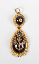 A gold, carbuncle garnet and diamond drop shaped pendant, probably Indian, the principal carbuncle