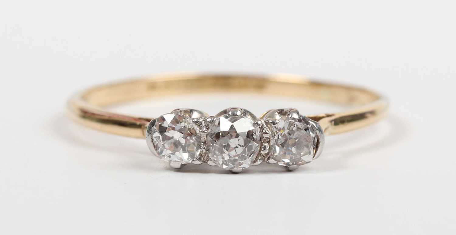 A gold, platinum and diamond three stone ring, claw set with a row of old cut diamonds, detailed ‘ - Image 2 of 5