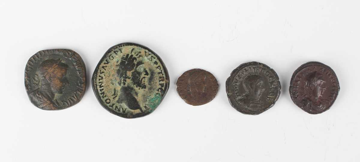 A group of five Roman coins, including an Antoninius Pius sestertius, reverse with Salus standing