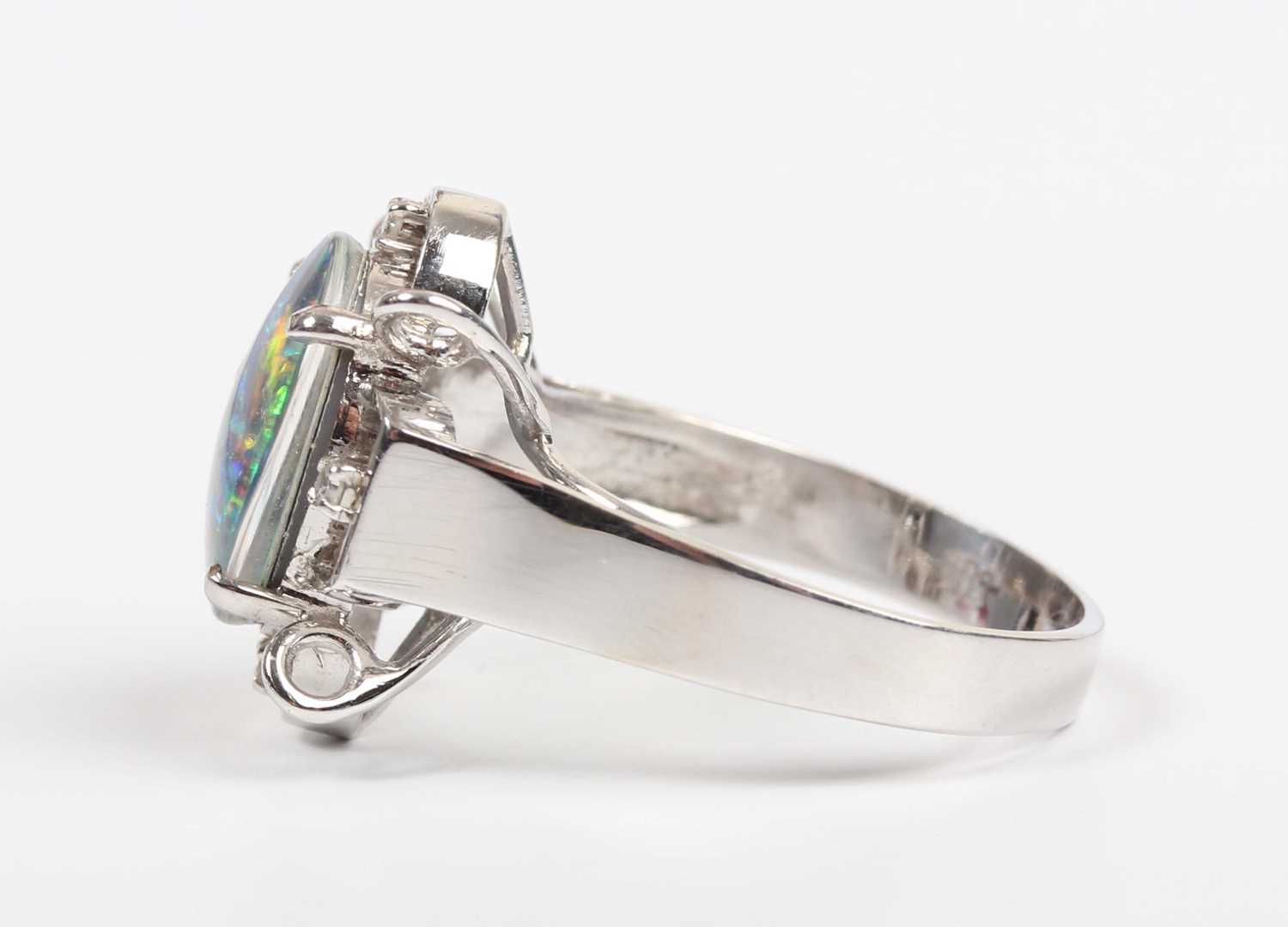 A white gold, opal triplet and diamond ring, claw set with the oval opal triplet in an openwork - Image 3 of 5