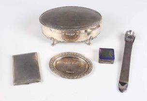 A George V silver oval jewellery box, the hinged lid with engine turned decoration, on scroll