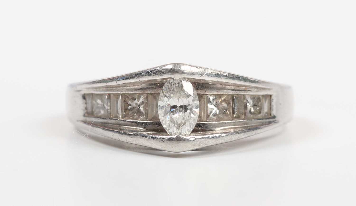 A platinum and diamond ring, mounted with the principal marquise shaped diamond in a raised - Image 2 of 5