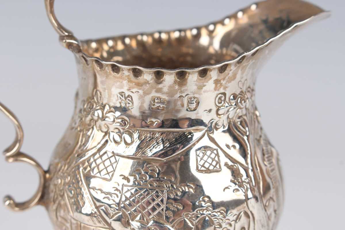 A George III silver oval cream jug, engraved with festoon tassel decoration, London 1801, height 9. - Image 6 of 6