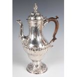 A George III silver baluster coffee pot with domed hinged lid and seed head finial above half-spiral