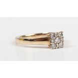 A 9ct gold and diamond square cluster ring, mounted with five principal circular cut diamonds and