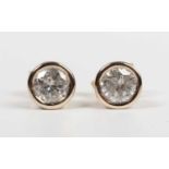 A pair of gold and diamond single stone earstuds, each collet set with a circular cut diamond,