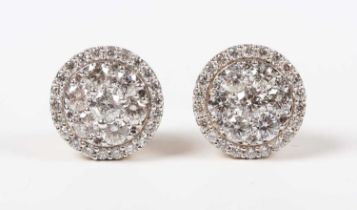 A pair of 14ct gold and diamond cluster earstuds, each mounted with the principal seven circular cut