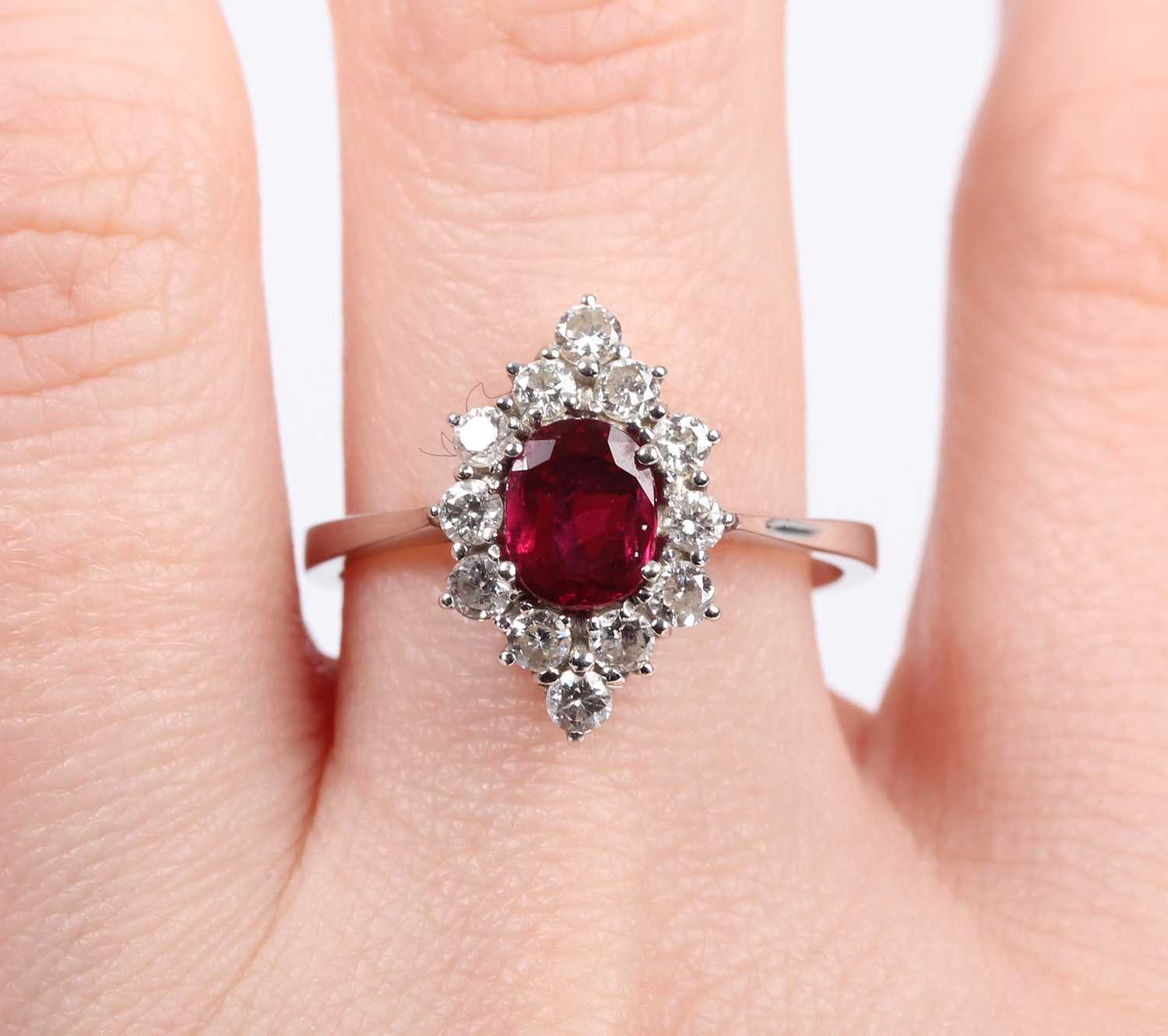 A ruby and diamond cluster ring, claw set with the oval cut ruby within a marquise shaped surround - Image 5 of 5