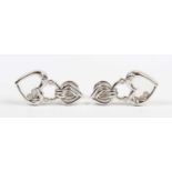 A pair of 18ct white gold and diamond pendant earrings, each designed as a stylised heart shaped