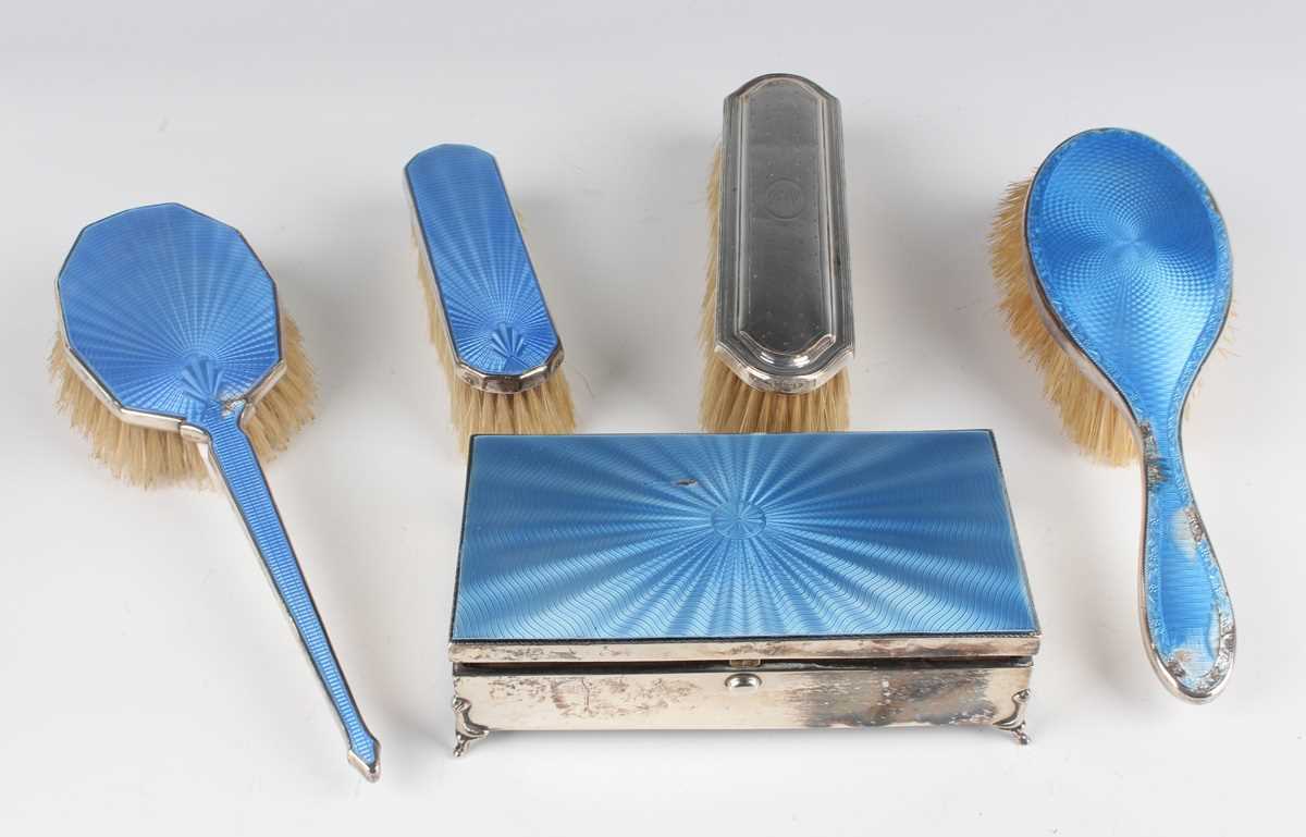 A George V silver and blue enamelled rectangular manicure box, the sprung lid revealing a matching