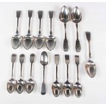 A harlequin set of seven George III and later silver Fiddle pattern dessert spoons and seven