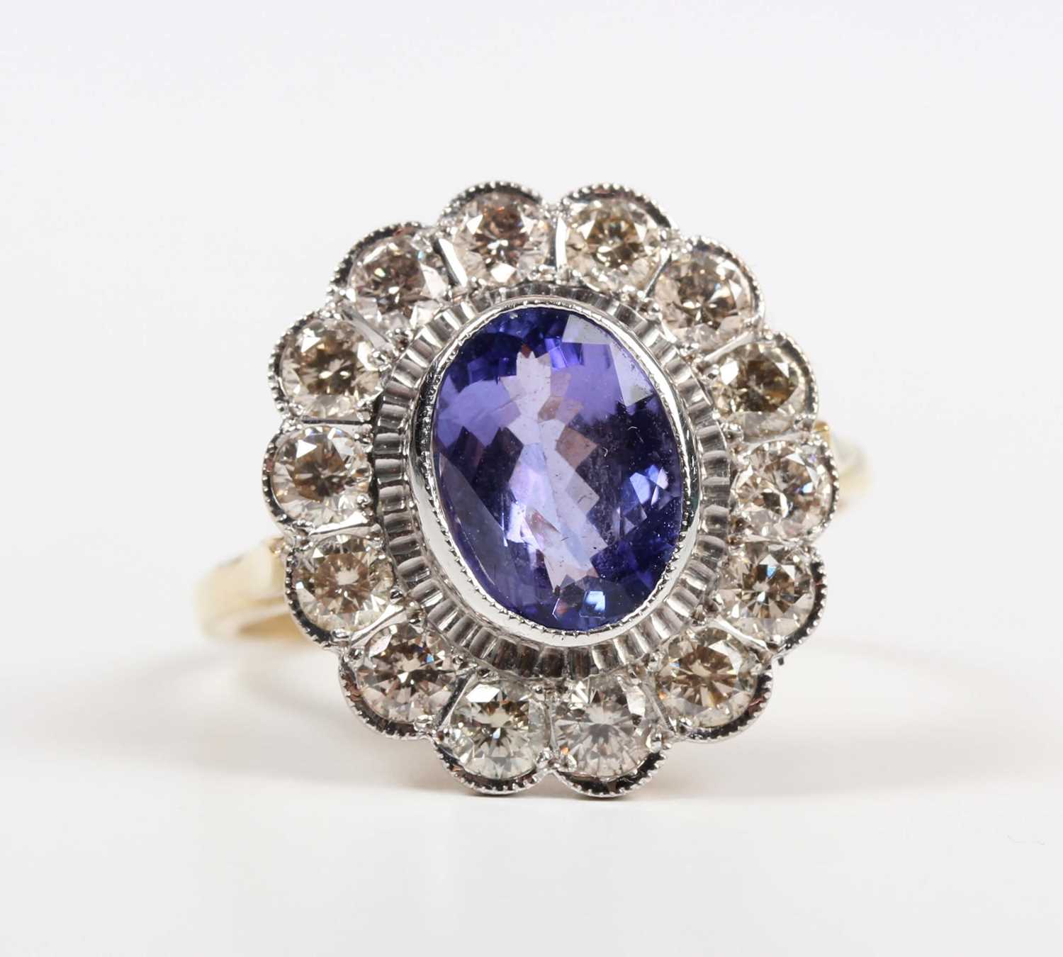 A gold, tanzanite and diamond oval cluster ring, collet set with the oval cut tanzanite within a - Image 2 of 5