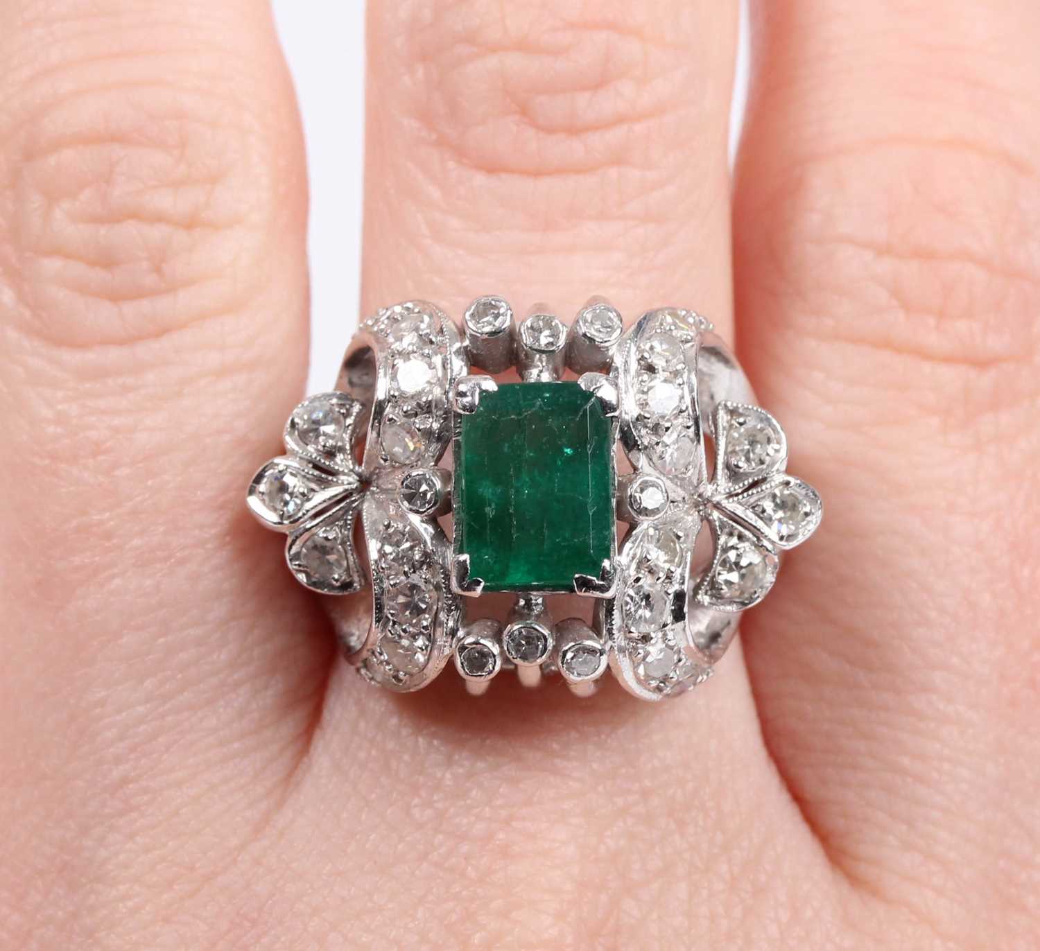 An emerald and diamond cocktail ring, claw set with the rectangular step cut emerald between - Image 5 of 5