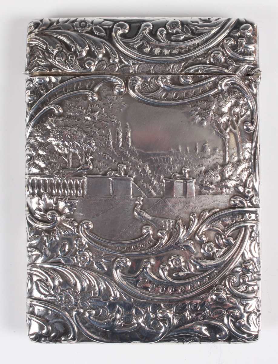 An Edwardian silver rectangular card case, the front decorated in relief with a musician and two - Image 2 of 3