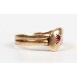 An 18ct gold ring designed as a coiled snake, the head mounted with a red gemstone, Chester 1916,