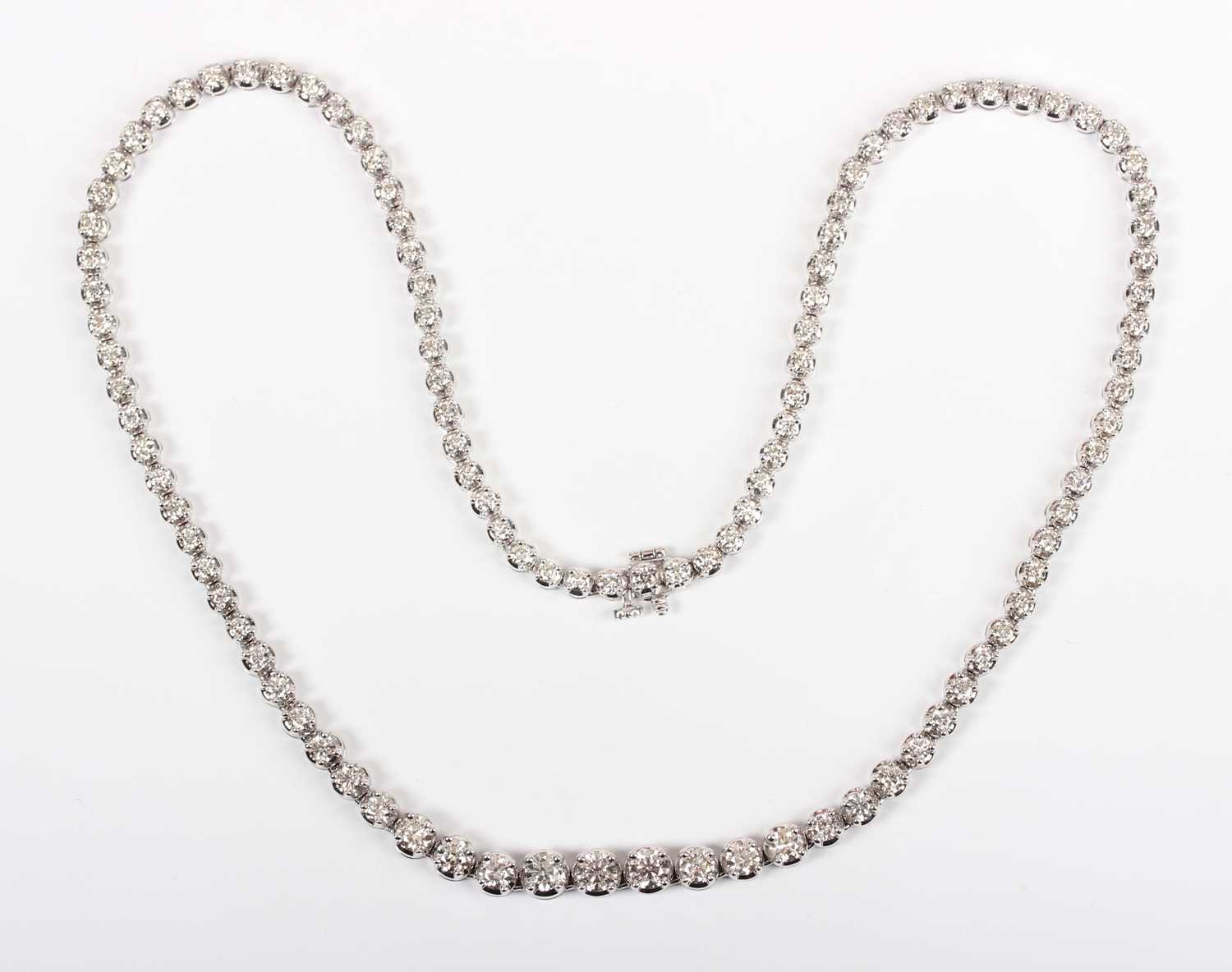 An 18ct white gold and diamond collar necklace, claw set with a row of graduated circular cut