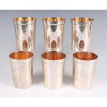 A set of six Elizabeth II silver beakers, each of slightly tapered cylindrical form with gilt