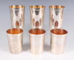 A set of six Elizabeth II silver beakers, each of slightly tapered cylindrical form with gilt