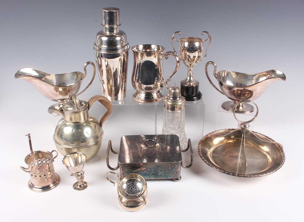 A group of plated items, including a swing-handled basket, two three-piece tea sets, a cocktail