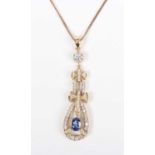 A gold, sapphire and diamond pendant, claw set with the oval cut sapphire within an openwork pear