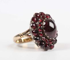 A gold, silver set and carbuncle garnet cluster ring, mounted with the principal carbuncle garnet at
