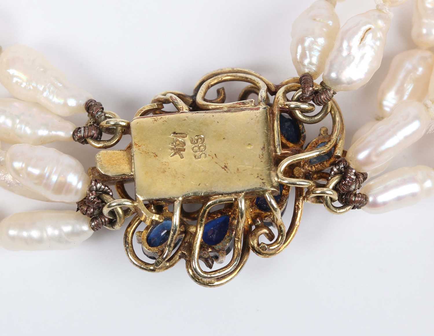 A five row necklace of freshwater cultured pearls on a gold and sapphire clasp, detailed ‘585 - Image 3 of 3