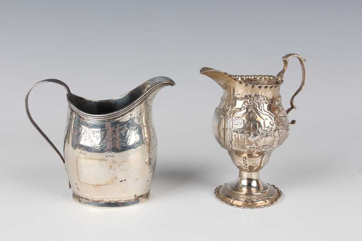 A George III silver oval cream jug, engraved with festoon tassel decoration, London 1801, height 9.