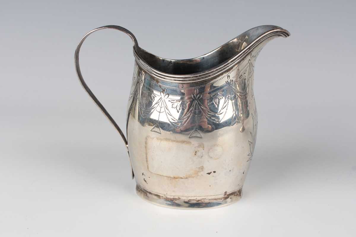 A George III silver oval cream jug, engraved with festoon tassel decoration, London 1801, height 9. - Image 2 of 6