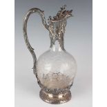 An early 20th century French silver mounted cut glass ewer, the hinged lid with floral finial