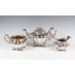 An early Victorian silver harlequin three-piece tea set of lobed melon form on stylized scallop