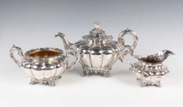 An early Victorian silver harlequin three-piece tea set of lobed melon form on stylized scallop