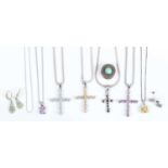 A small group of jewellery, including four silver and gem set pendant crosses, each detailed ‘