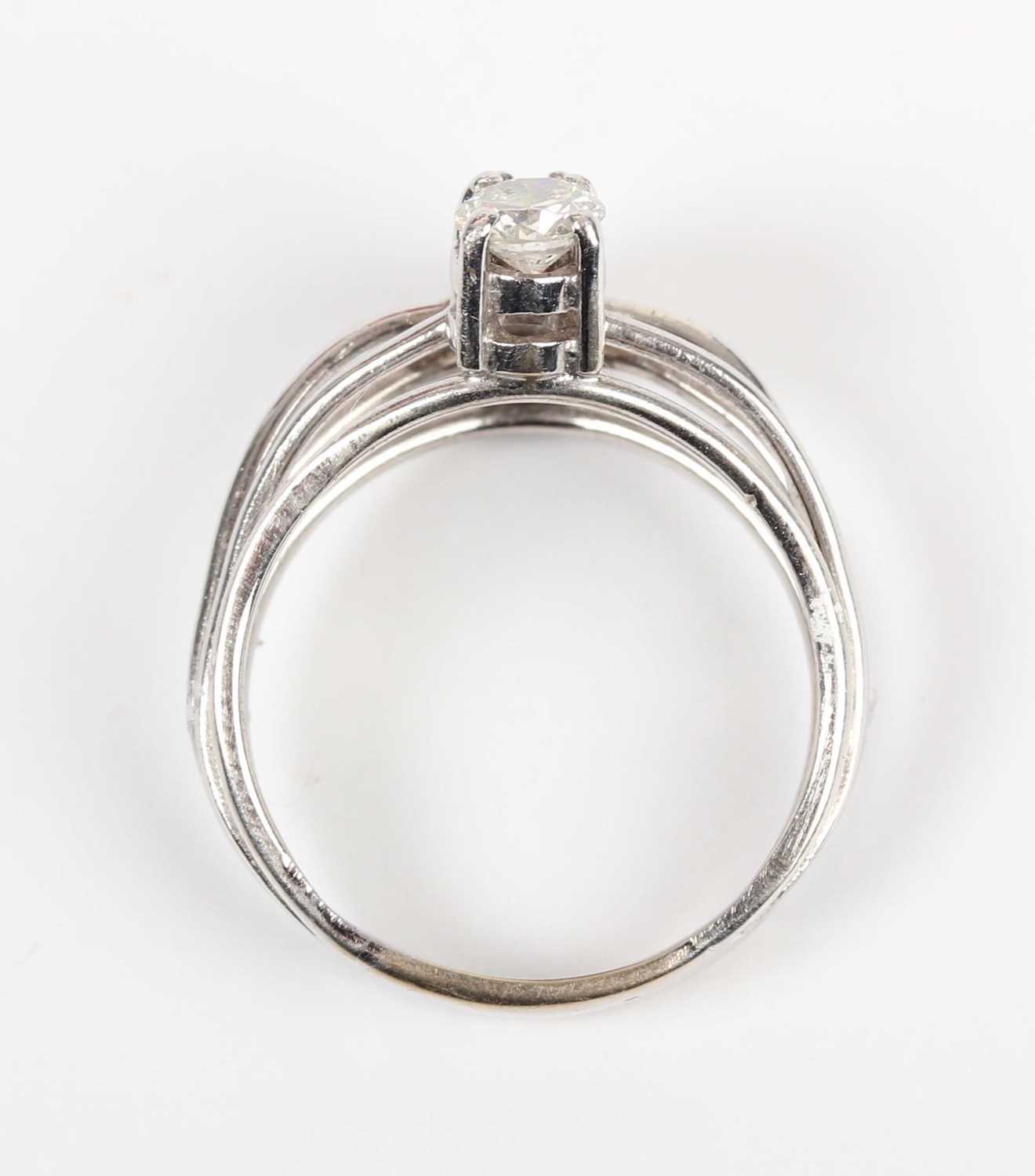 A diamond ring, claw set with a row of four circular cut diamonds between split sides, unmarked, - Image 4 of 5