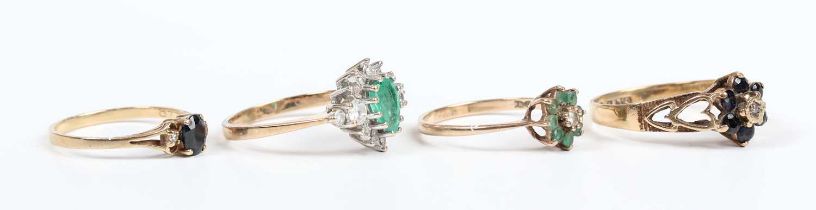 A 9ct gold, emerald and diamond cluster ring, claw set with a pear shaped emerald to the centre,